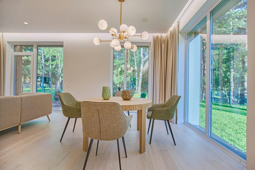 Elegant dining room featuring modern furniture and large windows for natural light.